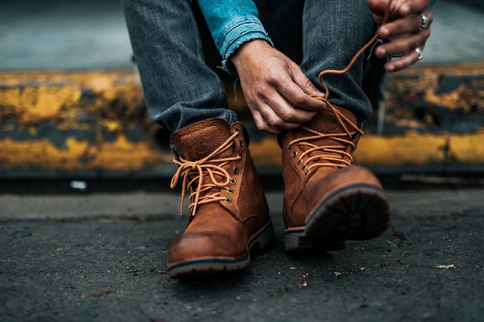 Photo of man tying boots